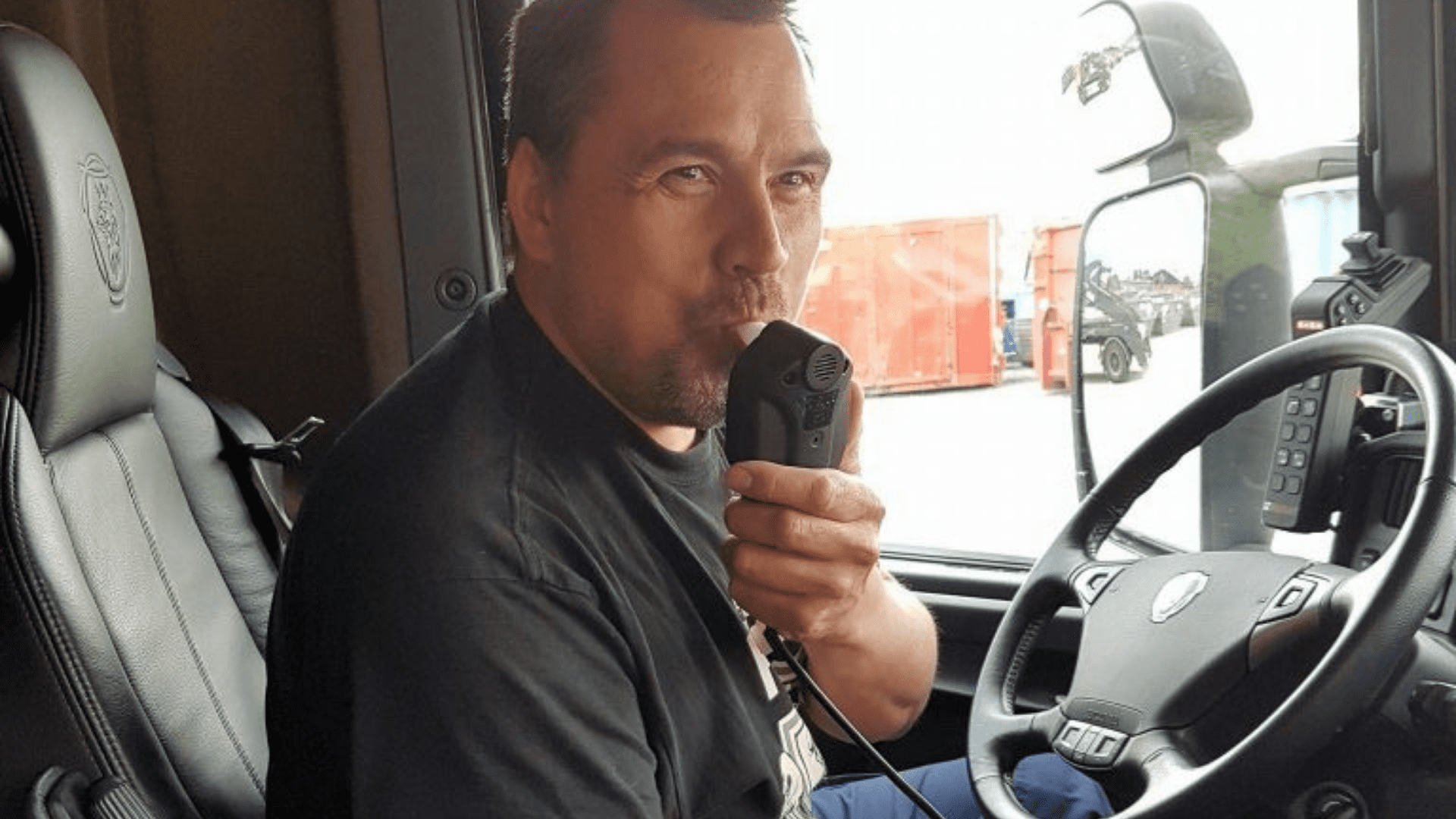 En bild på en lastbilschaufför som blåser i ett alkolås.
