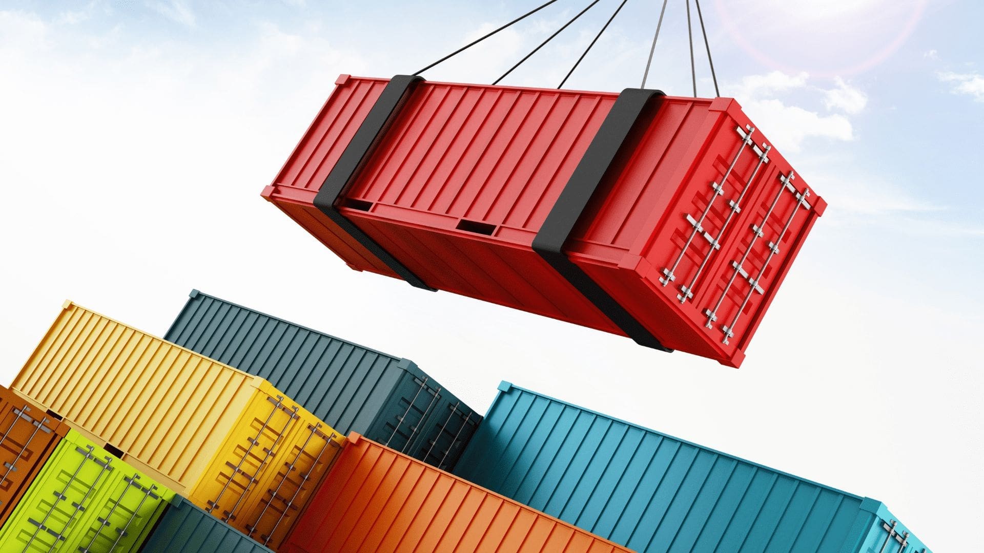 En plats med flera container. En röd container lastas på andra.